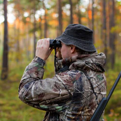 Hunter looking through binoculars