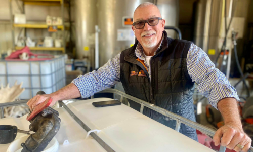 Drakes Farm Service employee filling a water tank